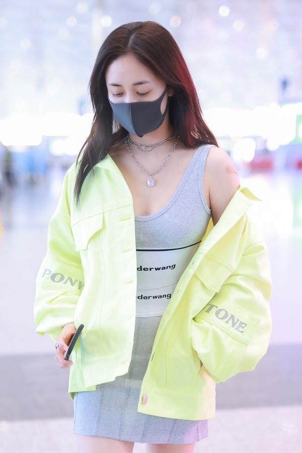 刘芸荧光绿外套搭灰色裙亮相机场 出现初秋运动女团风
